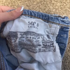 Size 4, Levi’s 501 blue ripped jeans